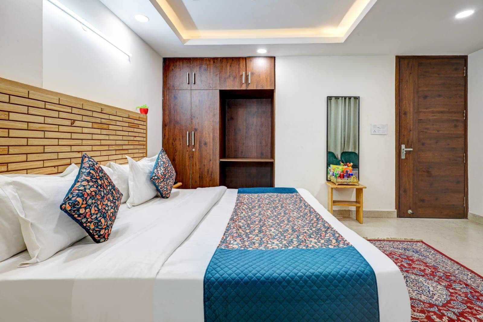 Premium Room with a white bed, patterned cushions, and wood furnishings